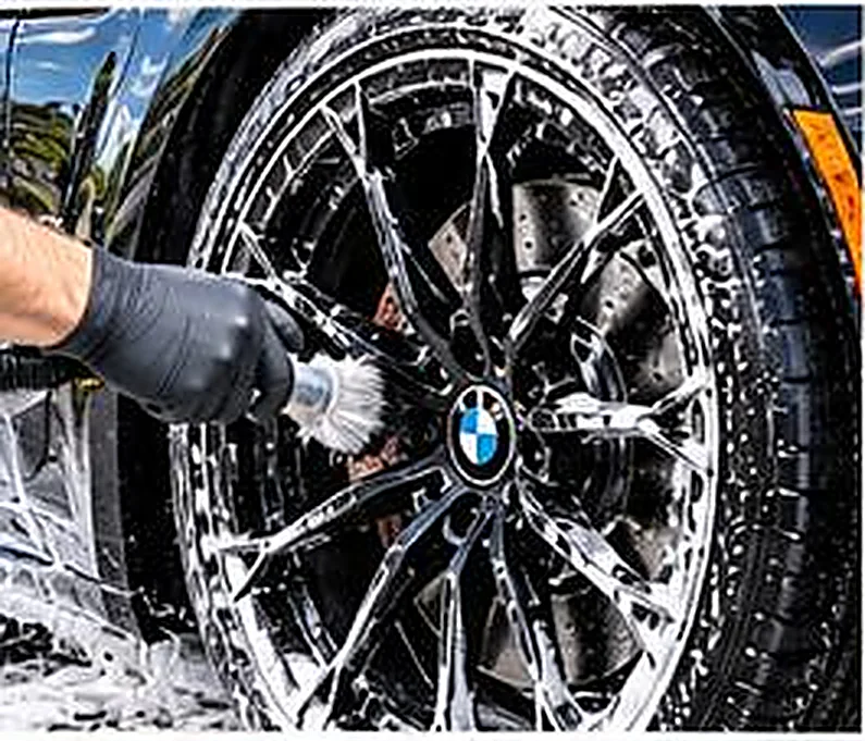 Cleaning a vehicle wheel with soap and a wash mitt