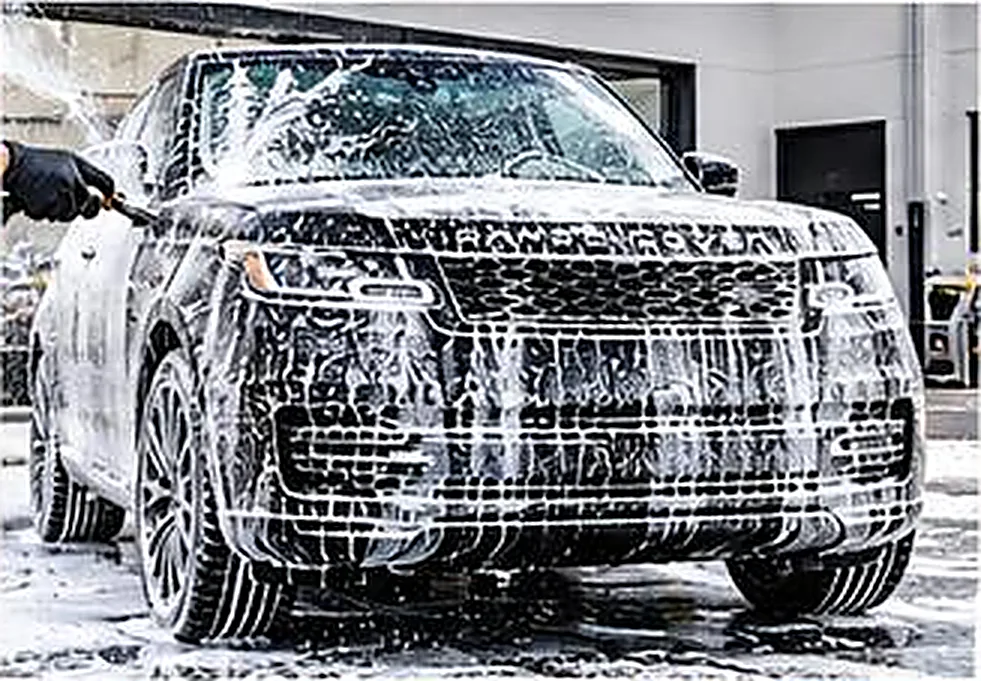 Vehicle covered in snow foam during a wash